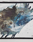 Black floater frames and abstract art piece by Finnish artist Lotta Sirén with black, blue, and white colors on a wall.