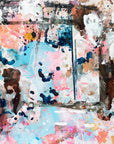 An abstract painting featuring a vibrant mix of colors including black, blue, brown, light blue, pink, white, and yellow, with an accidental smiley face in the middle.