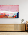 Detours Approved - Limited Edition Canvas Print on a living room wall above a tv stand. Piece with pink, white and burnt sienna tones and a hint of red & blue.