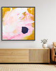 Free - Limited Edition Canvas Print with bold strokes, ocher, white and pink tones and an accent of blue. Abstract canvas print with black frames above a TV stand.
