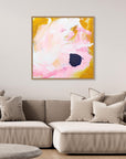 Free - Limited Edition Canvas Print with bold strokes, ocher, white and pink tones and an accent of blue. Abstract canvas print with oak frame above a couch.