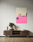 Abstract painting on a wall above a wooden console table with decorative items.