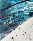 Close up of an abstract art piece by Finnish artist Lotta Sirén with black, blue, and white colors on a wall.