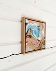 Framed abstract artwork on a white wooden wall by Finnish artist Lotta Sirén