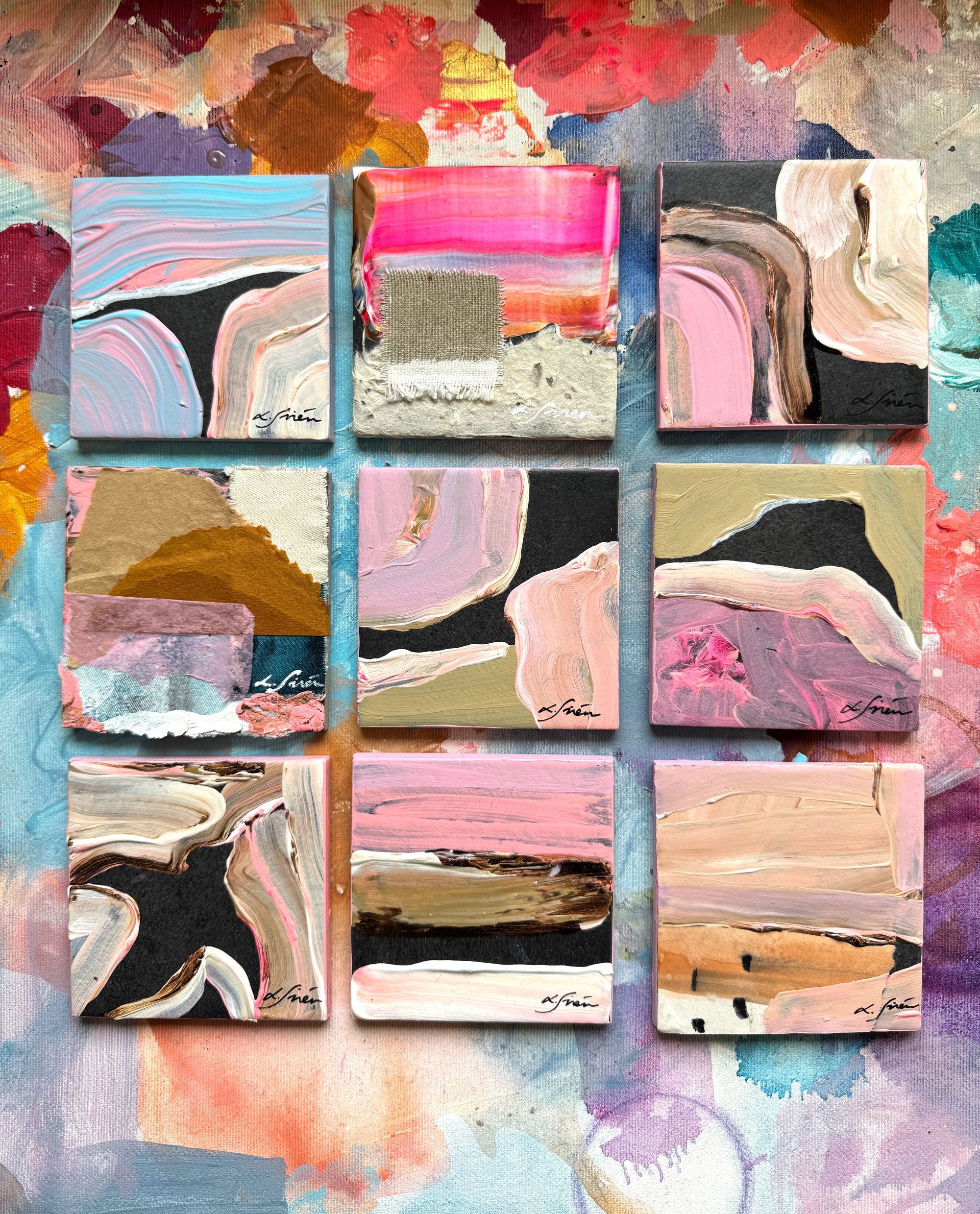 Collage of small abstract paintings with various color palettes on a textured background.