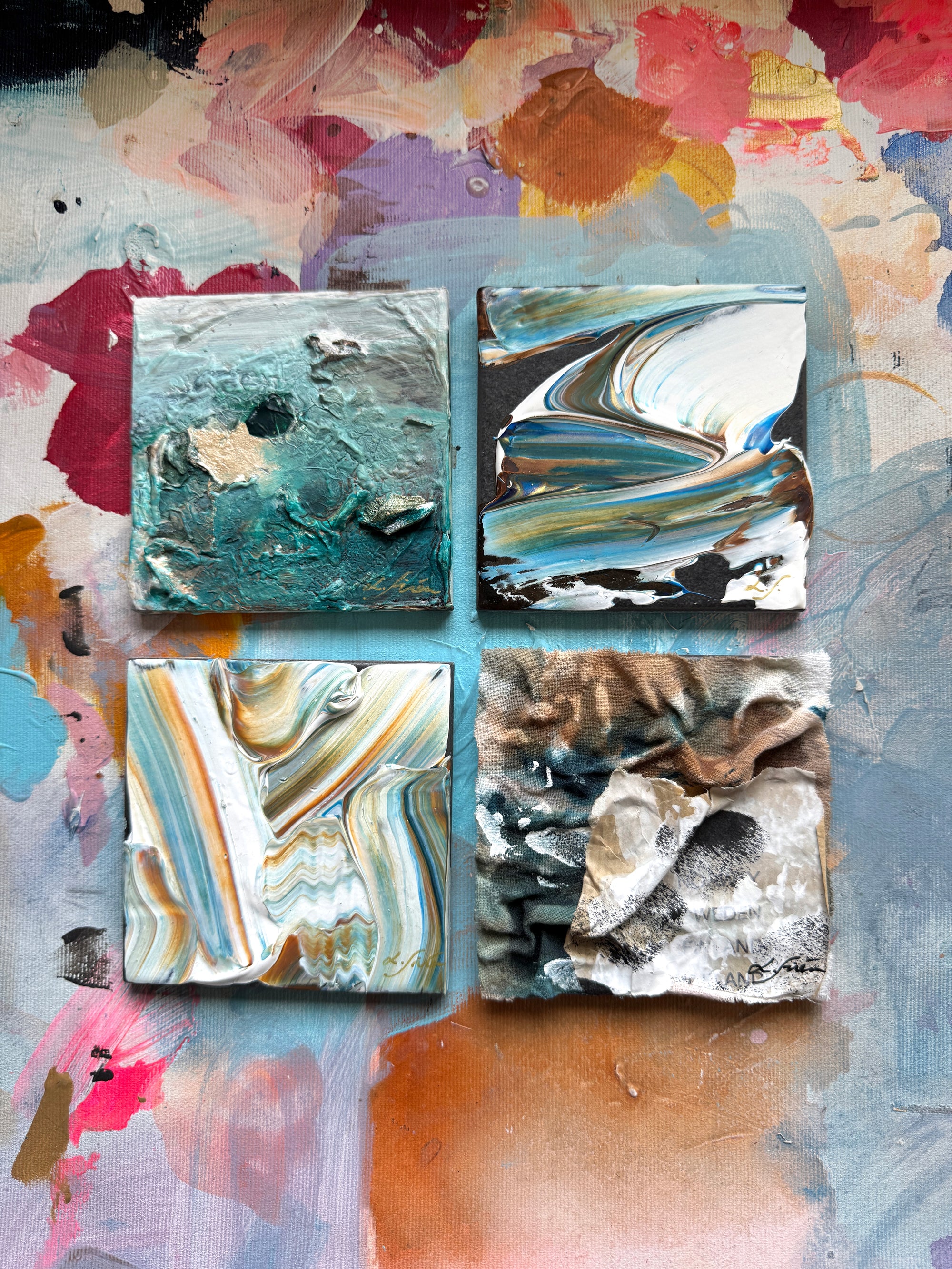 Four square abstract artworks with marbled patterns on a colorful abstract background