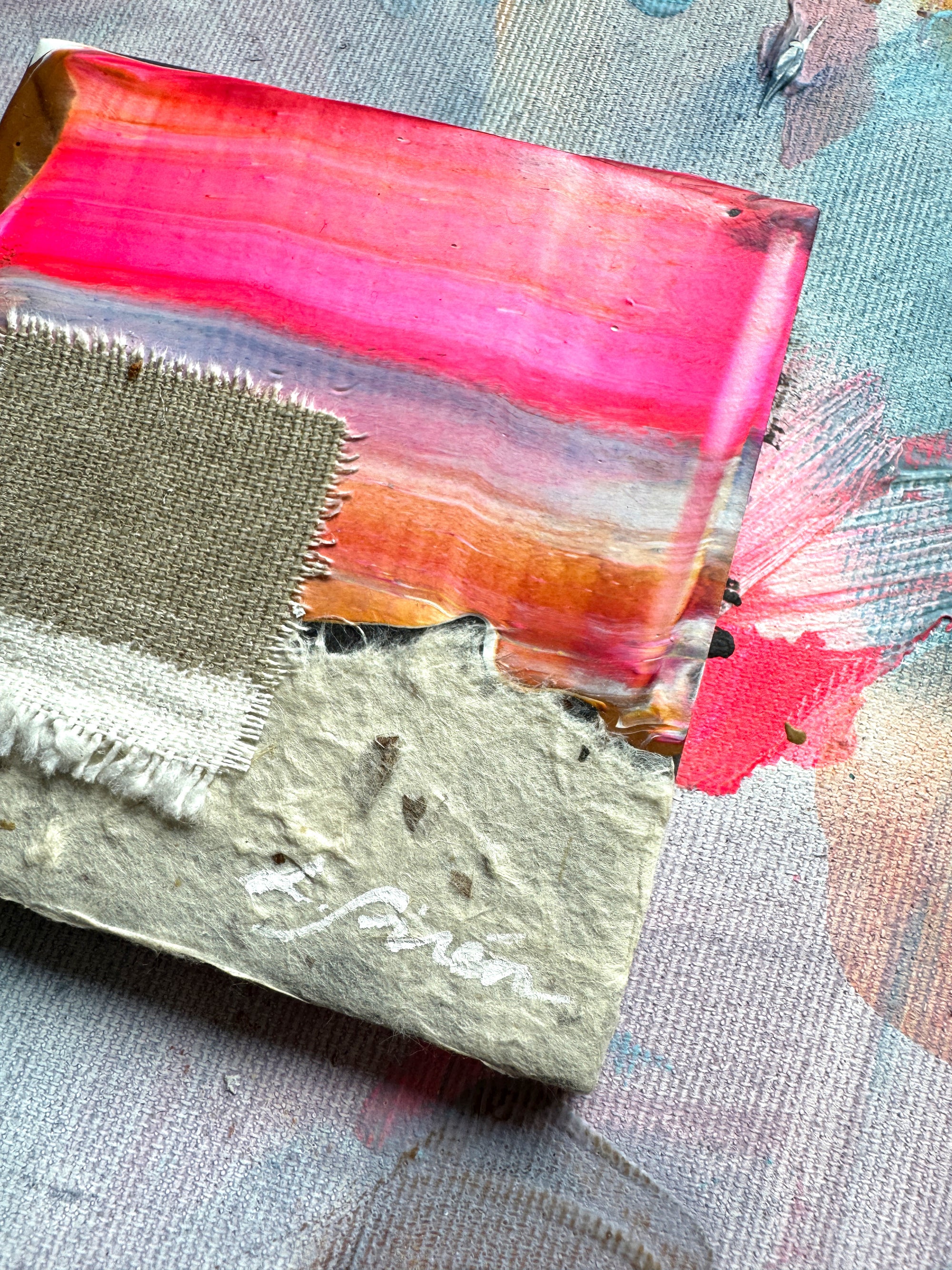 Colorful ceramic abstract art piece with pink, orange on a textured surface by artist Lotta Sirén.