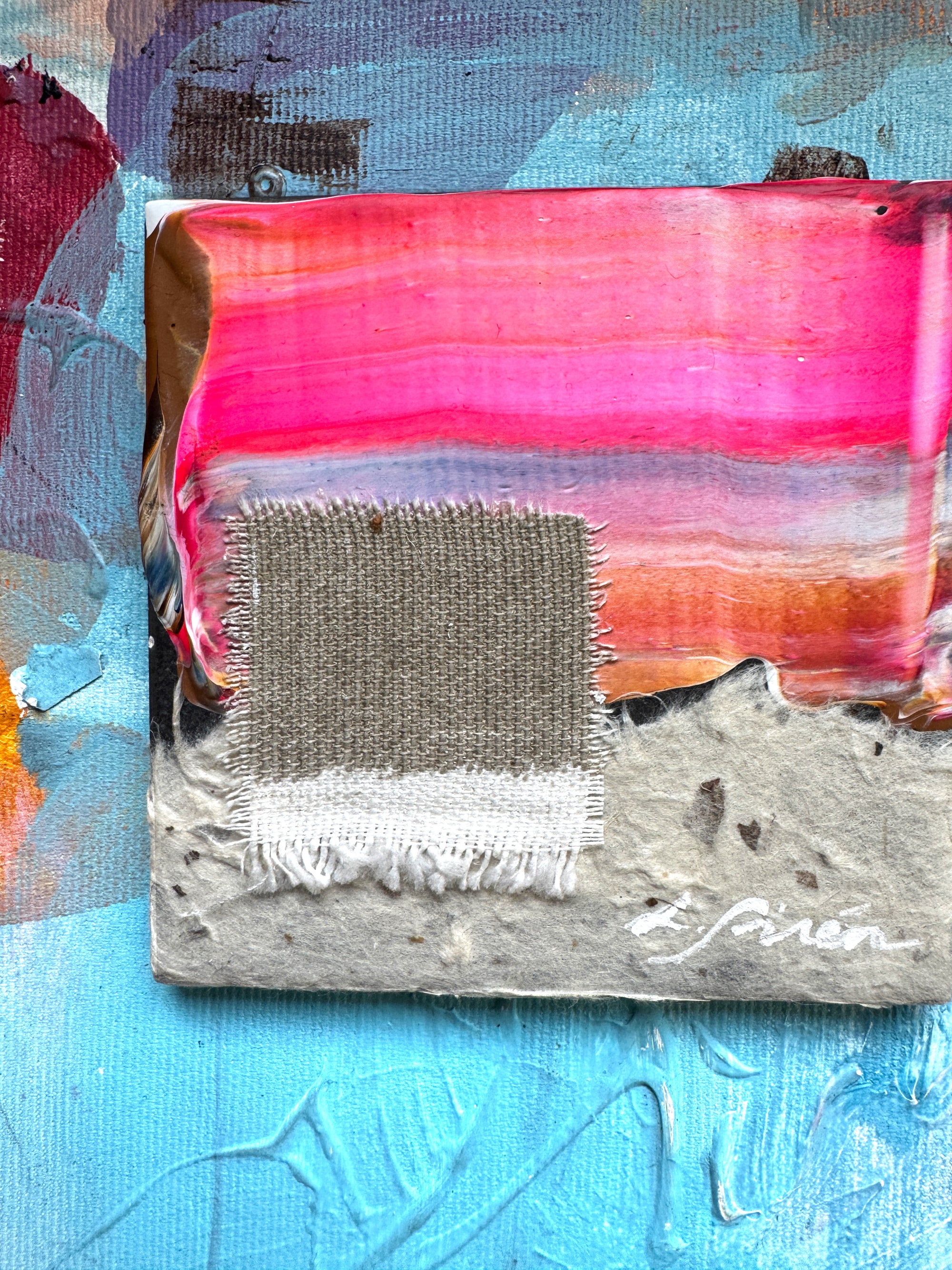 Ceramic abstract artwork  with pink, blue, and greige colors on a textured surface.