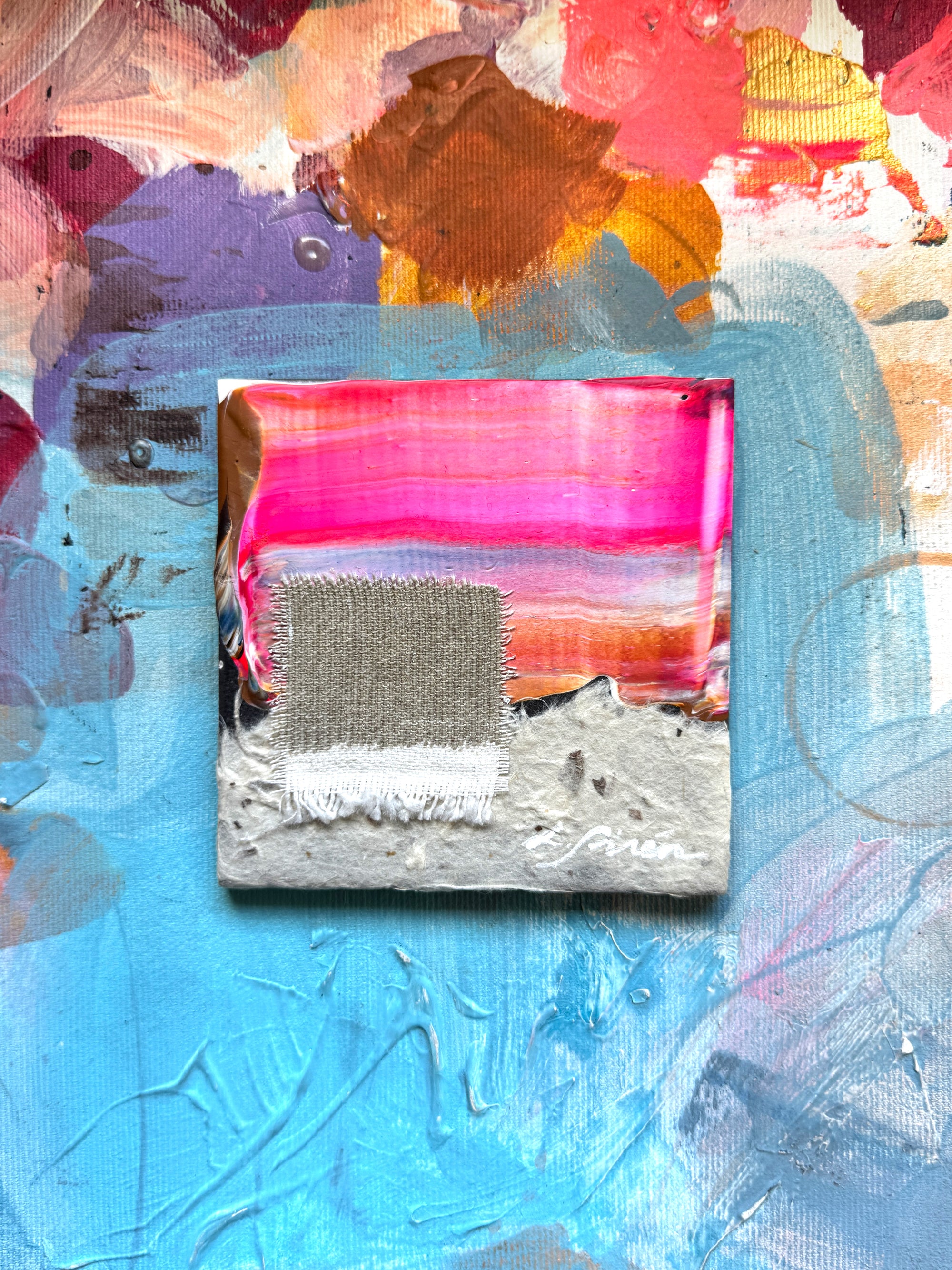 A ceramic abstract art piece with colorful textures and a central square.