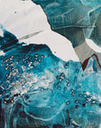 Close-up of an abstract art piece with teal, white, and black colors
