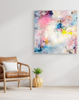 UFO (& other flying vehicles) - Canvas Print. A semi-abstract canvas print on a wall. A light piece with off-white, pastel tones and blue, pink and yellow hues.