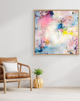 UFO (& other flying vehicles) - Canvas Print. A semi-abstract canvas print with oak frame on a wall. A light piece with off-white, pastel tones and blue, pink and yellow hues.