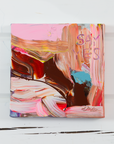 Colorful abstract painting on a white wooden surface