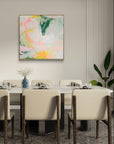 Dining room with a modern abstract painting on the wall, table set for four, and decorative elements.