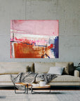 A large abstract painting on a wall above a beige sofa with decorative items. By abstract artist Lotta Sirén.
