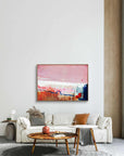 Detours Approved - Limited Edition Canvas Print with oak frames on a living room wall above a tv stand. Piece with pink, white and burnt sienna tones and a hint of red & blue. Modern living room with a white sofa, wooden coffee table, and abstract art on the wall.