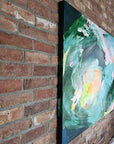 Abstract painting leaning against a brick wall by Lotta Sirén