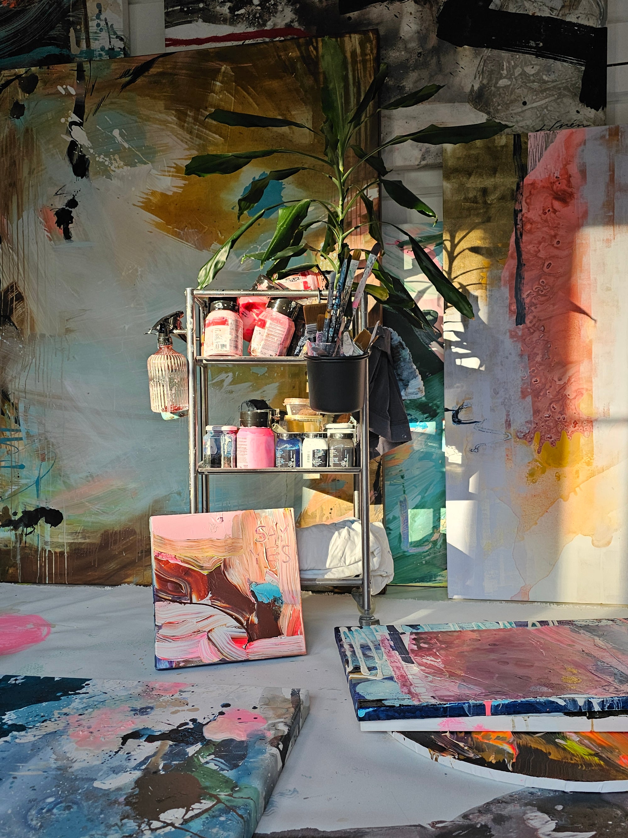 Lotta Sirén&#39;s art studio with various paintings and art supplies