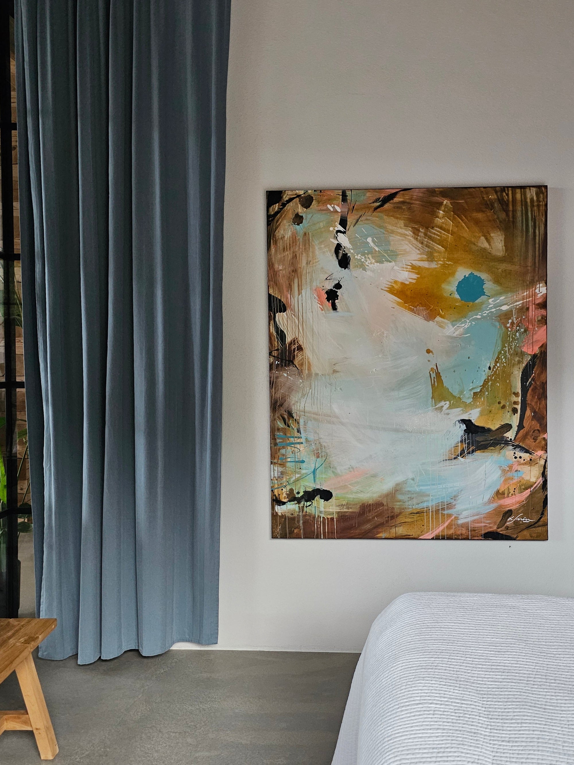 Abstract painting by Lotta Sirén on a wall above a bed in a modern bedroom with a glass wall.