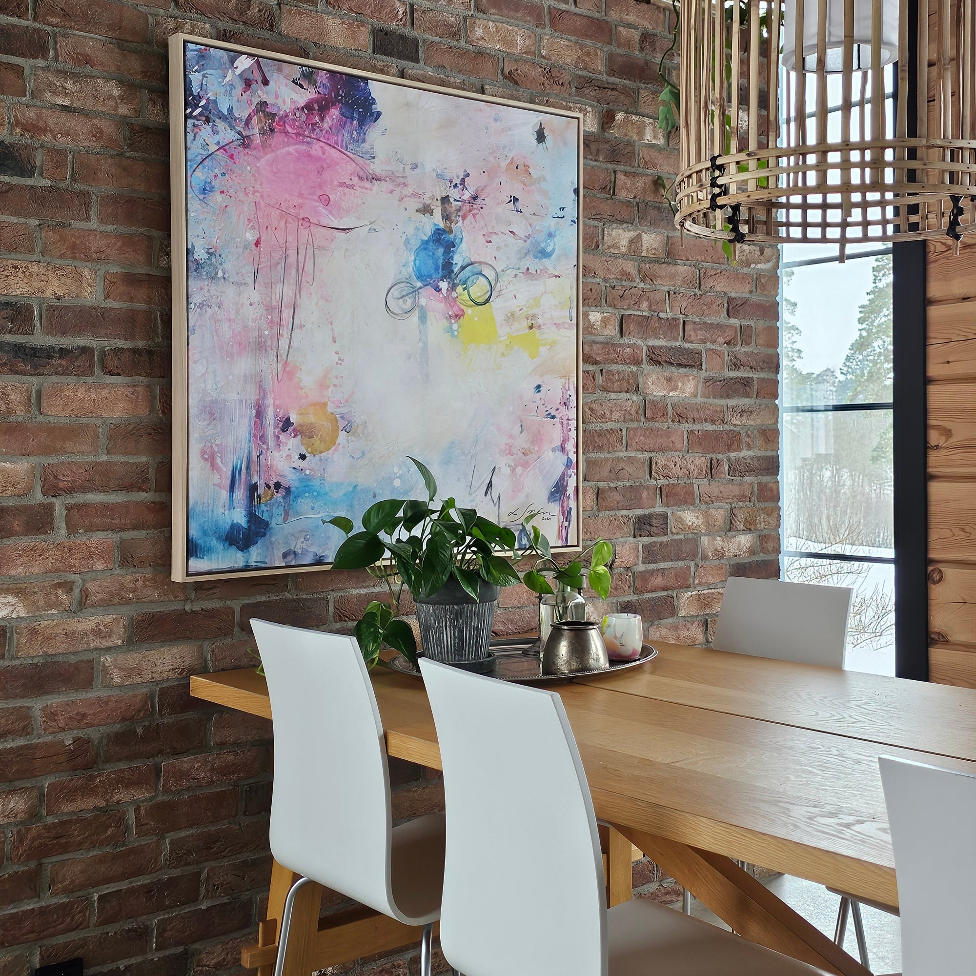 Colorful abstract painting on a brick wall with modern furniture and decor.