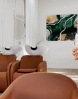 Modern interior with brown chairs and a abstract painting by Lotta Sirén on the wall.