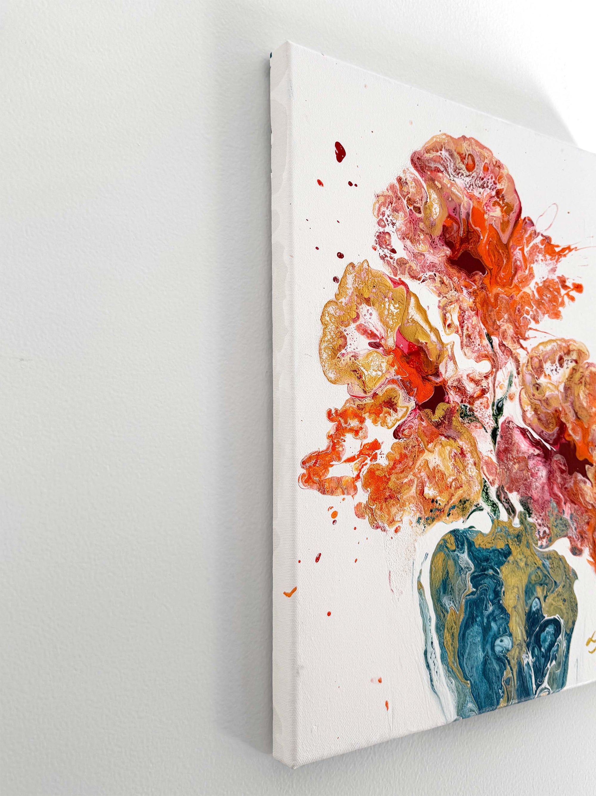 A semi-abstract floral painting on a white wall pictured from the side 
