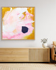 Free - Limited Edition Canvas Print with bold strokes, ocher, white and pink tones and an accent of blue. Abstract canvas print with oak frames above a TV stand. 