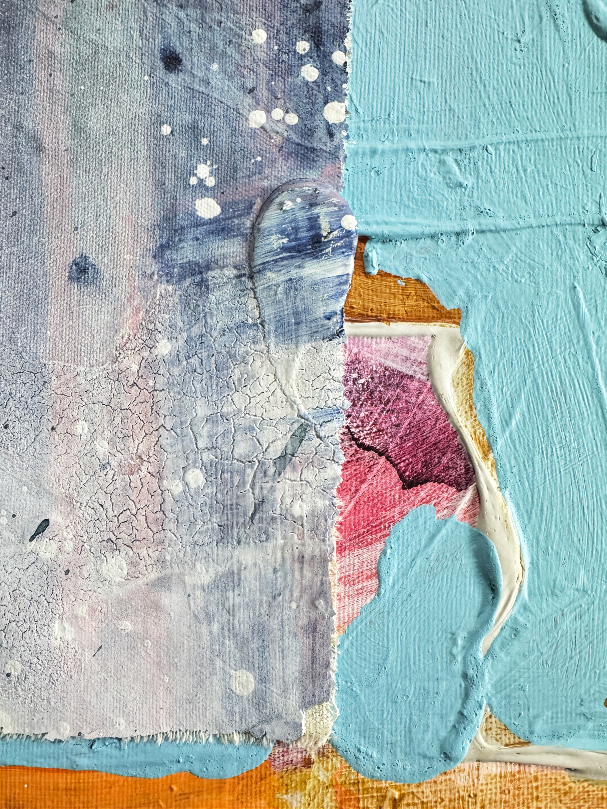 Close-up of a textured surface with abstract art, featuring a palette knife and colorful brush strokes.