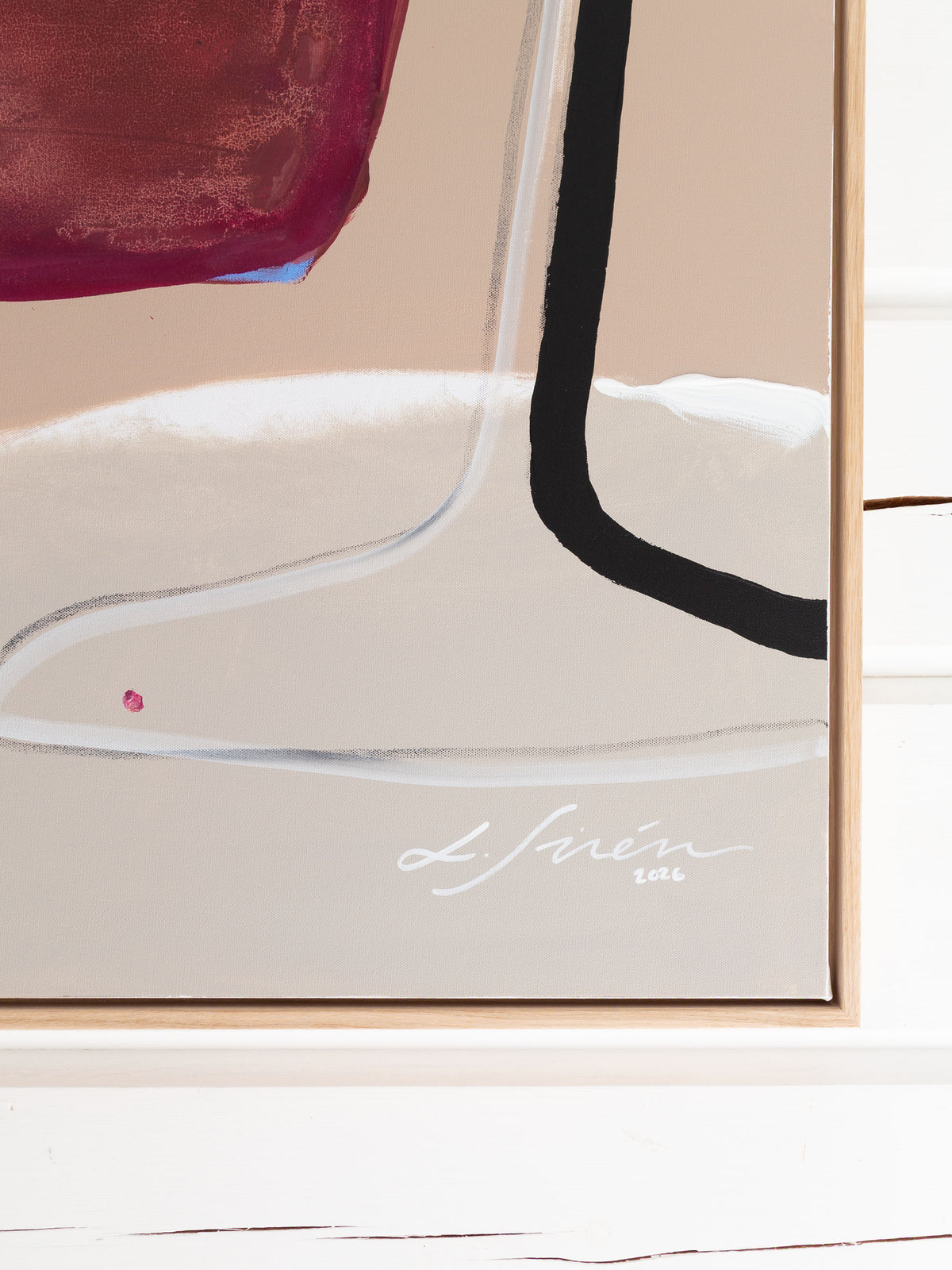 Large framed abstract painting featuring a beige background with bold black and white colors, a deep magenta in the upper left, and a white artist signature reading Lotta Sirén 2026 near the bottom.