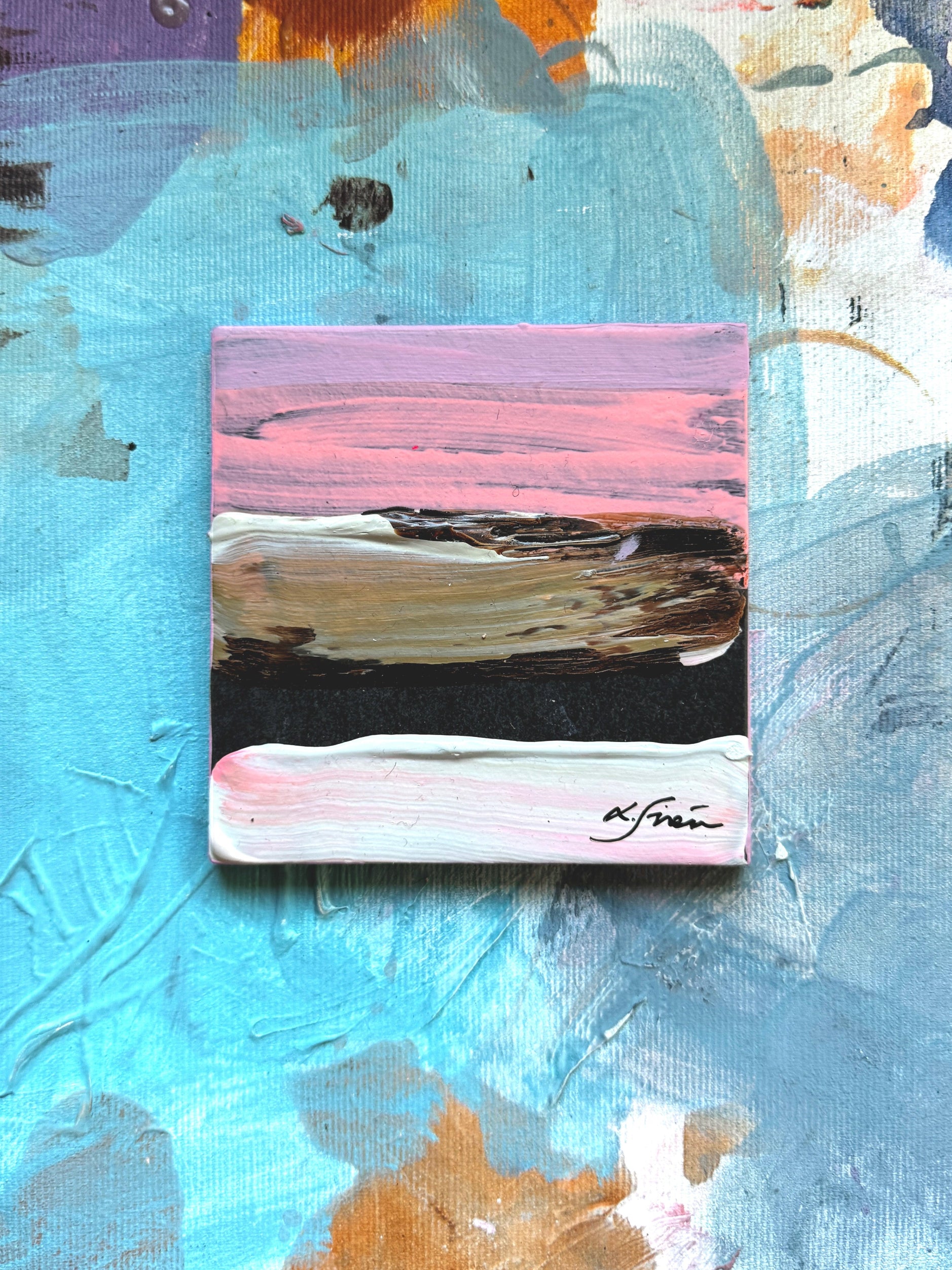 Abstract painting with a central square design on a textured background