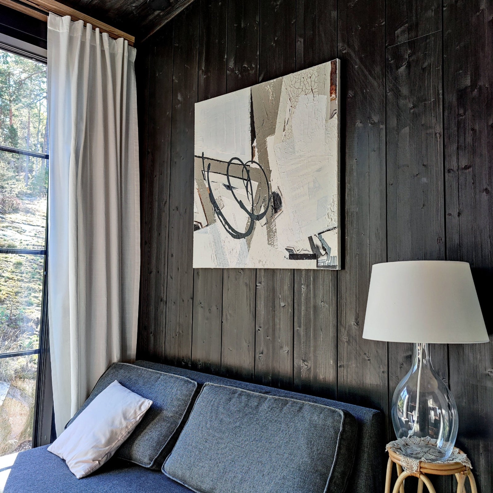 Empowering abstract artwork by Lotta Sirén above a sofa.