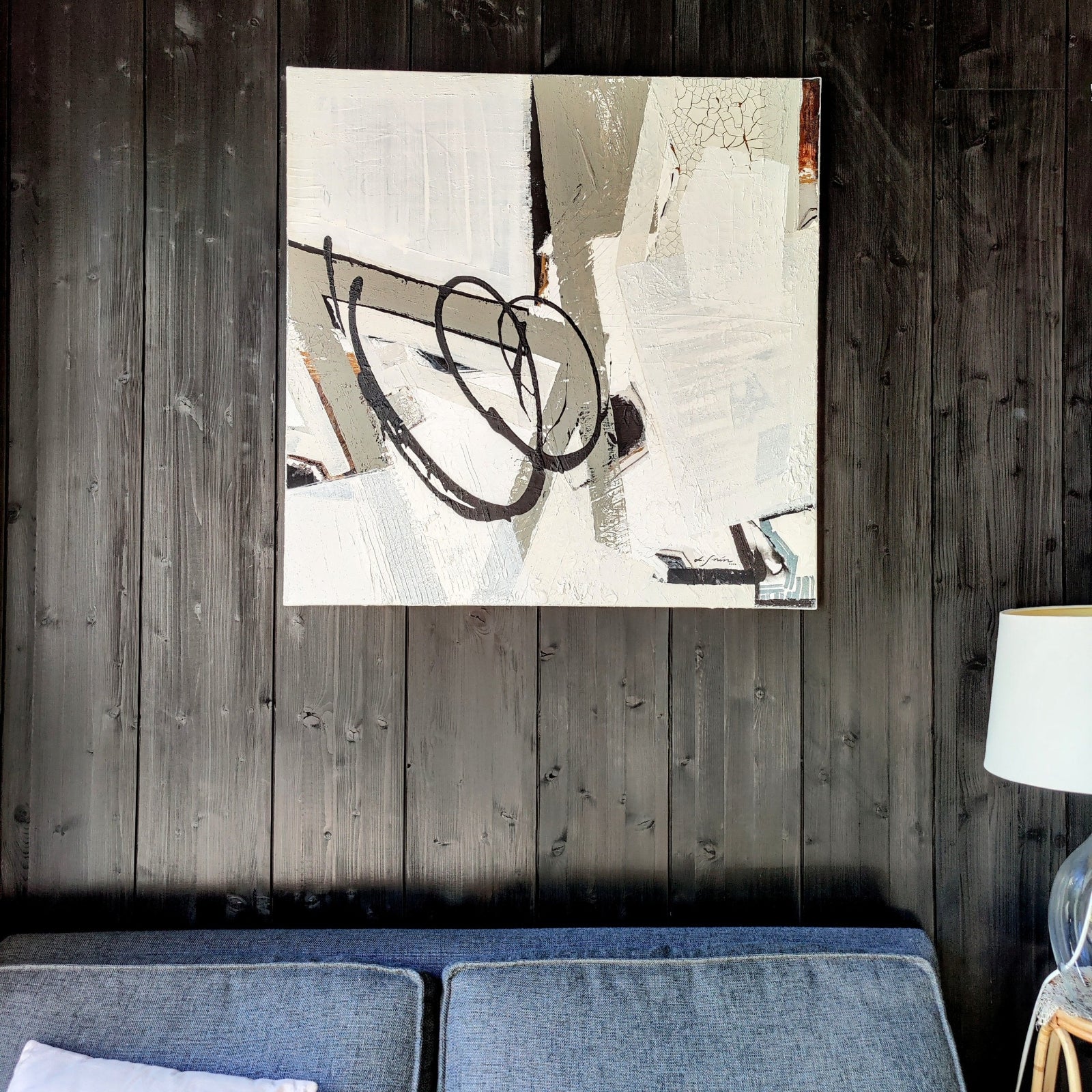 Empowering abstract artwork by Lotta Sirén on a black wooden wall.