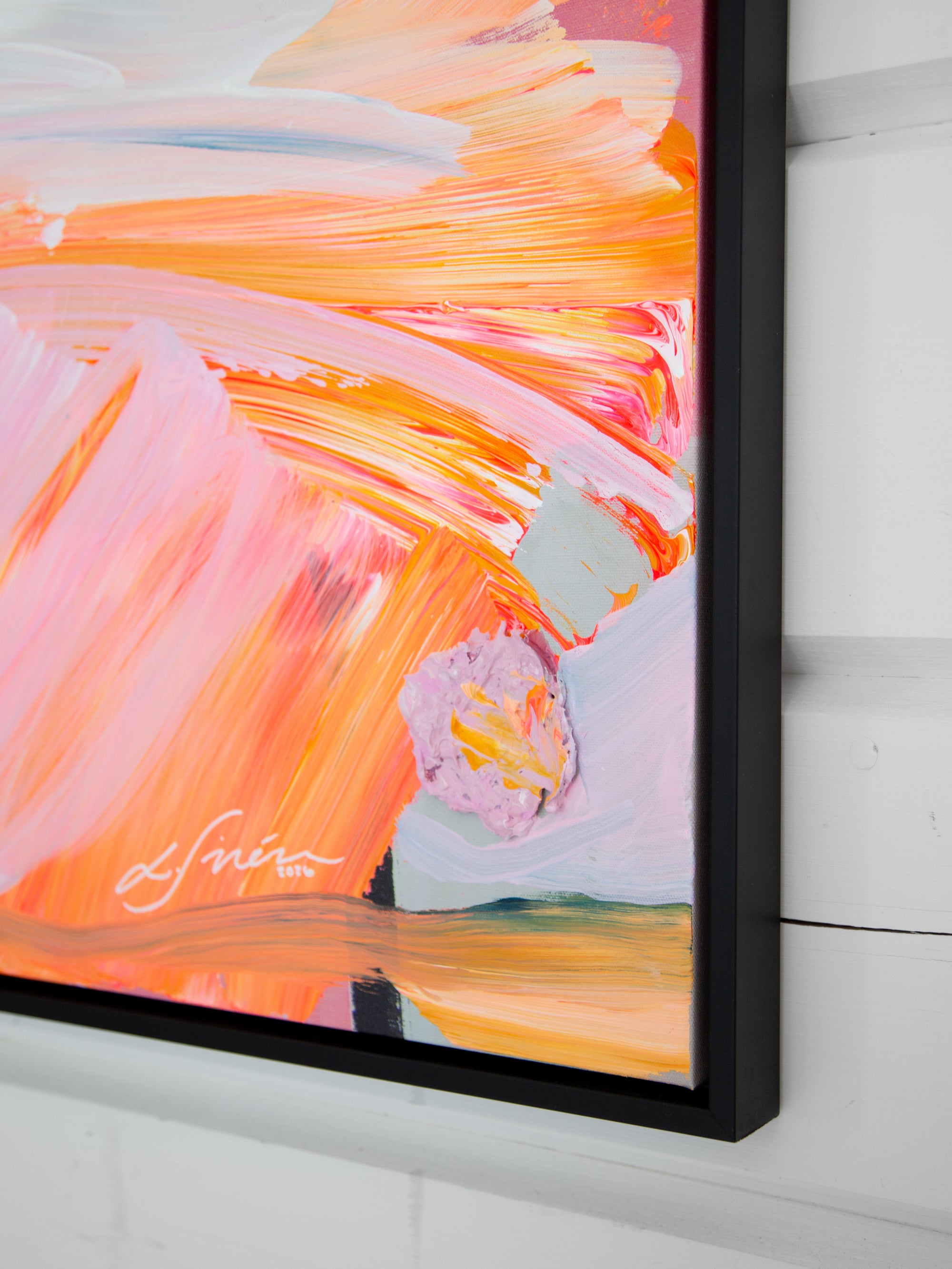 Abstract painting with vibrant colors on a white wall and signature by artist Lotta Sirén