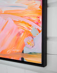 Abstract painting with vibrant colors on a white wall and signature by artist Lotta Sirén