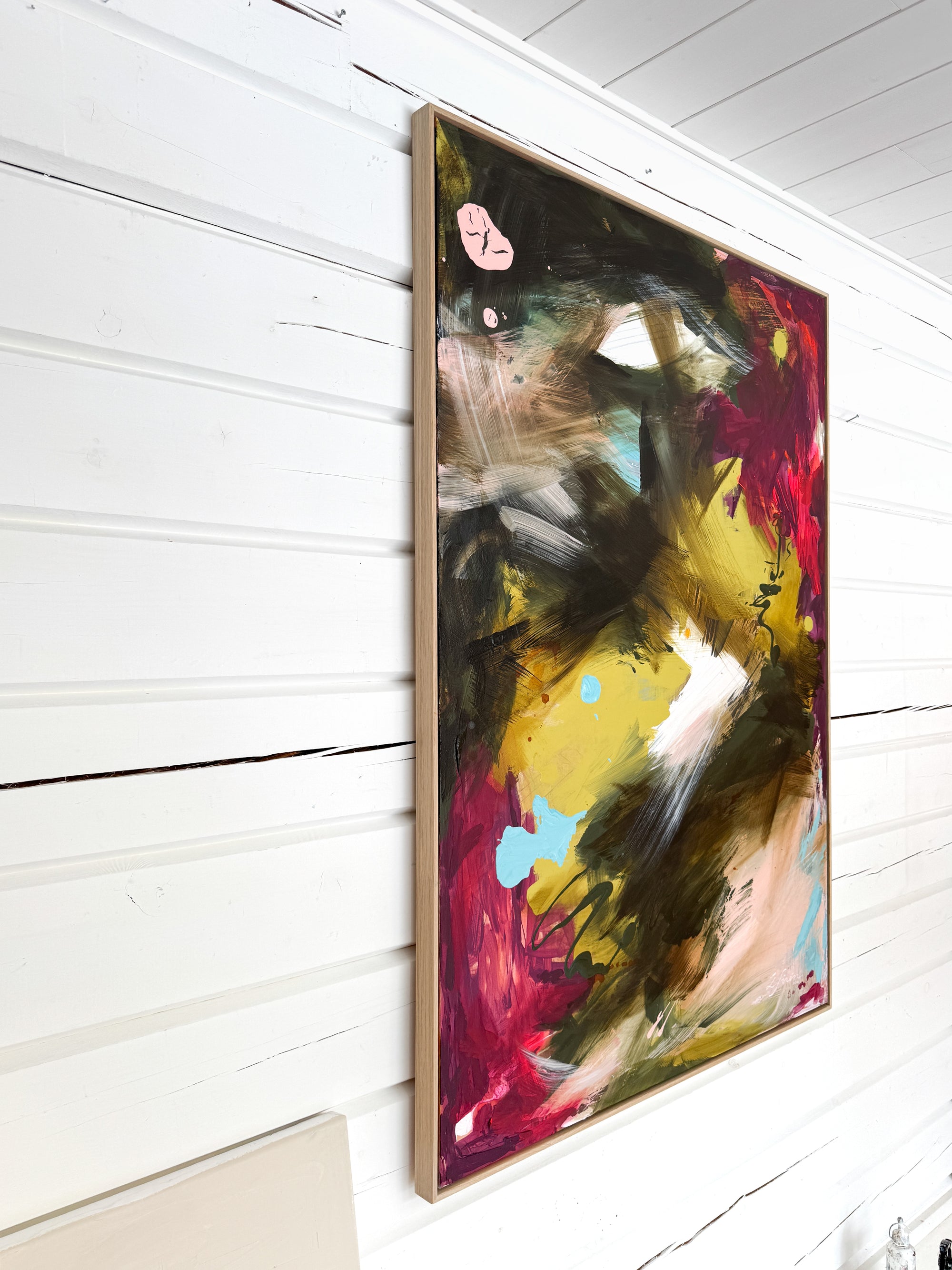 Colorful abstract painting by Finnish emerging artist Lotta Sirén on a white wall