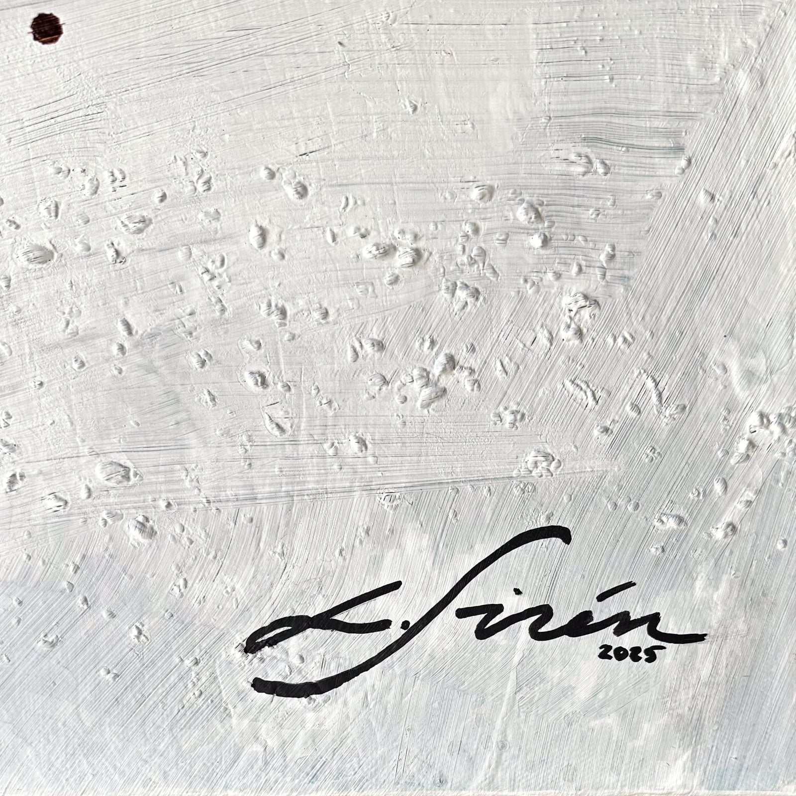 Textured white surface with a Lotta Sirén signature and year 2025
