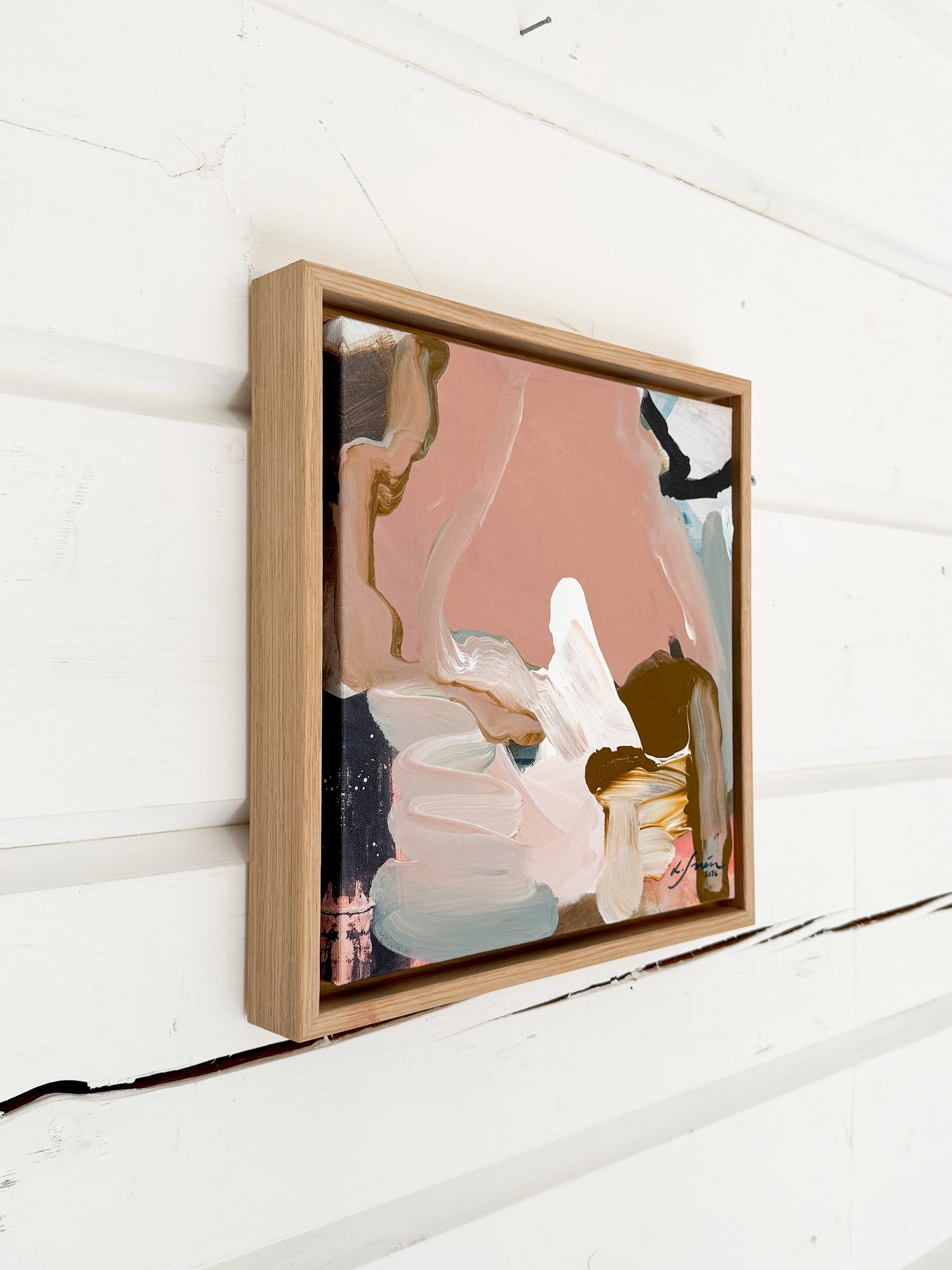 Framed abstract art piece on a white wooden wall  by abstract artist Lotta Sirén