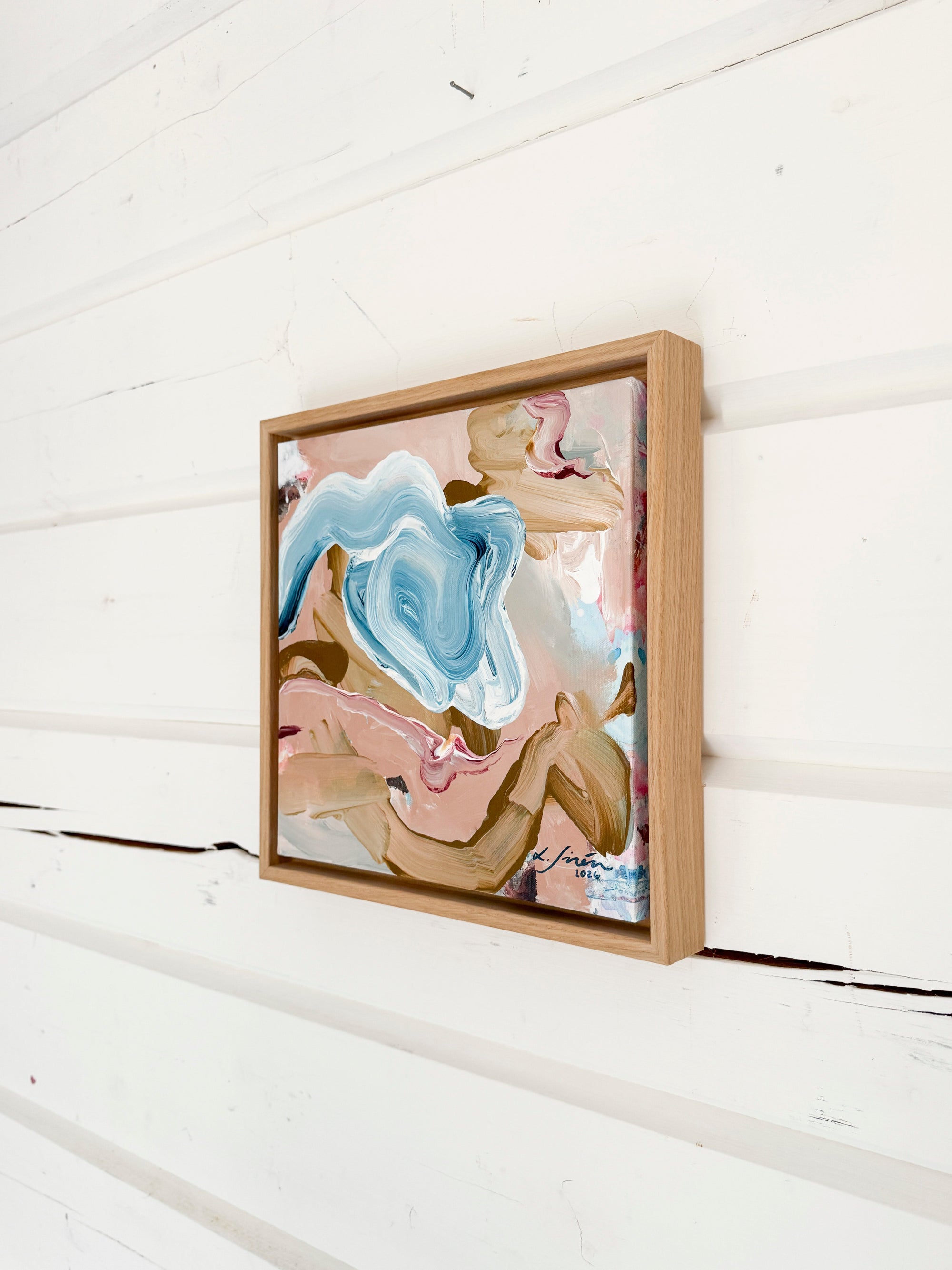 Framed abstract art piece on a white wooden wall by Finnish artist Lotta Sirén