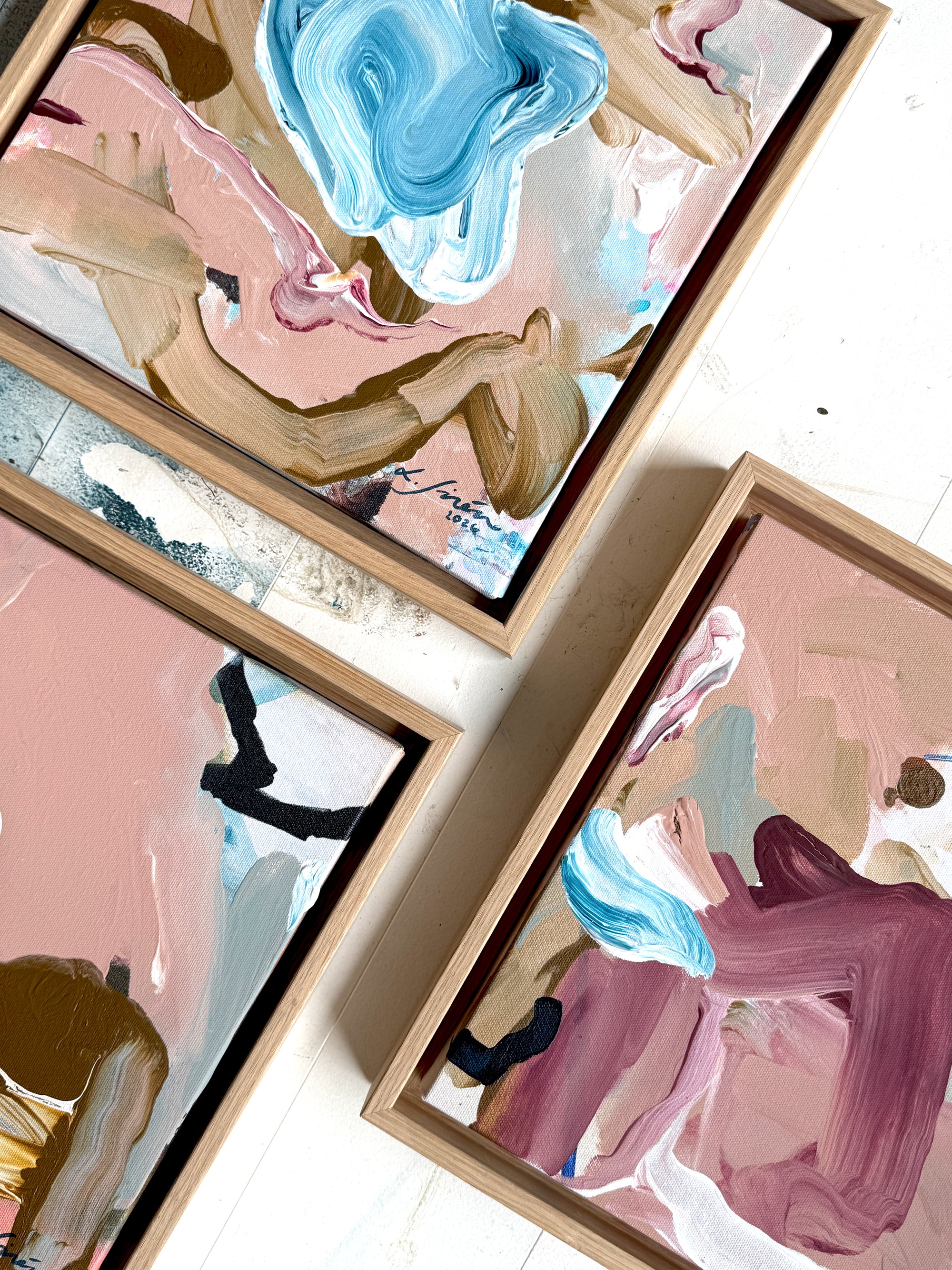 Framed abstract artworks with a focus on color and texture.