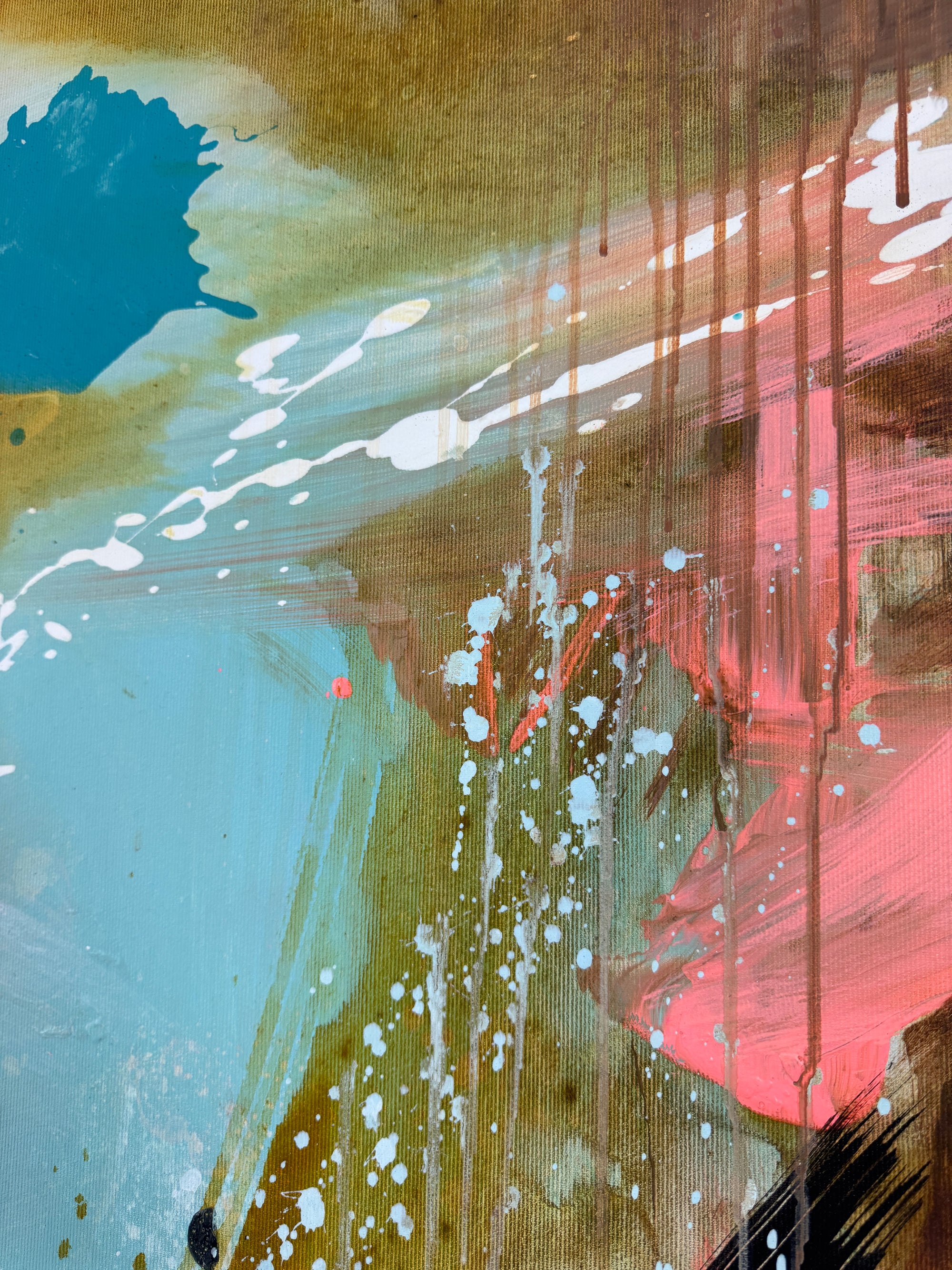Close up of an abstract art with splashes of white, coral pink, and blue on a textured canvas