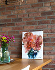 Colorful semi-abstract painting on a table leaning against a brick wall  by Finnish artist Lotta Sirén