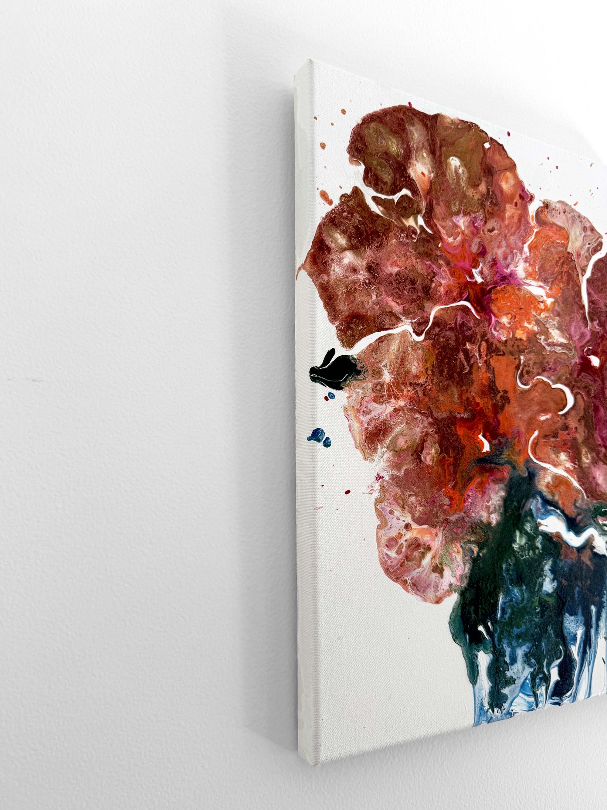 A semi-abstract acrylic painting from a side on a white surface 