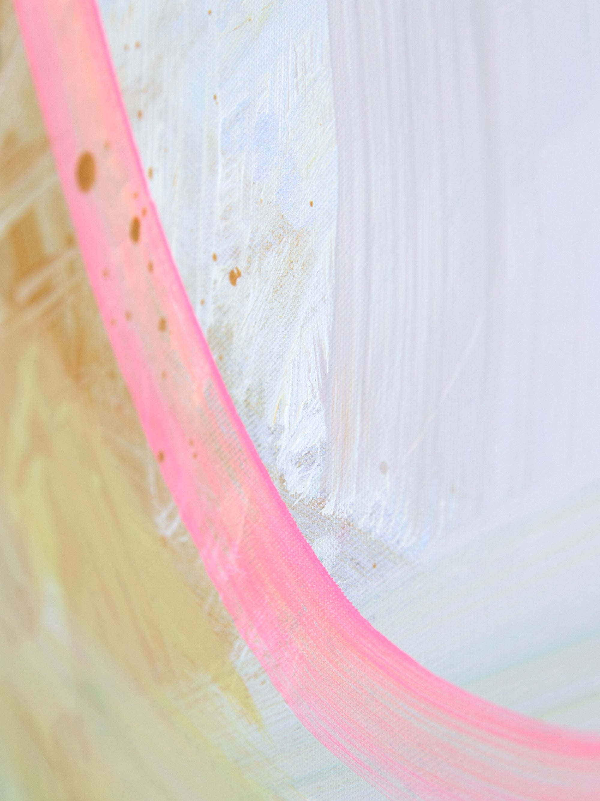 Close-up of an abstract painting with  pink and yellow hues on a textured white background