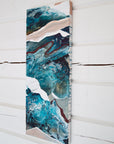 Abstract art piece with blue and white colors on a wooden panel against a white wooden background by Finnish abstract artist Lotta Sirén