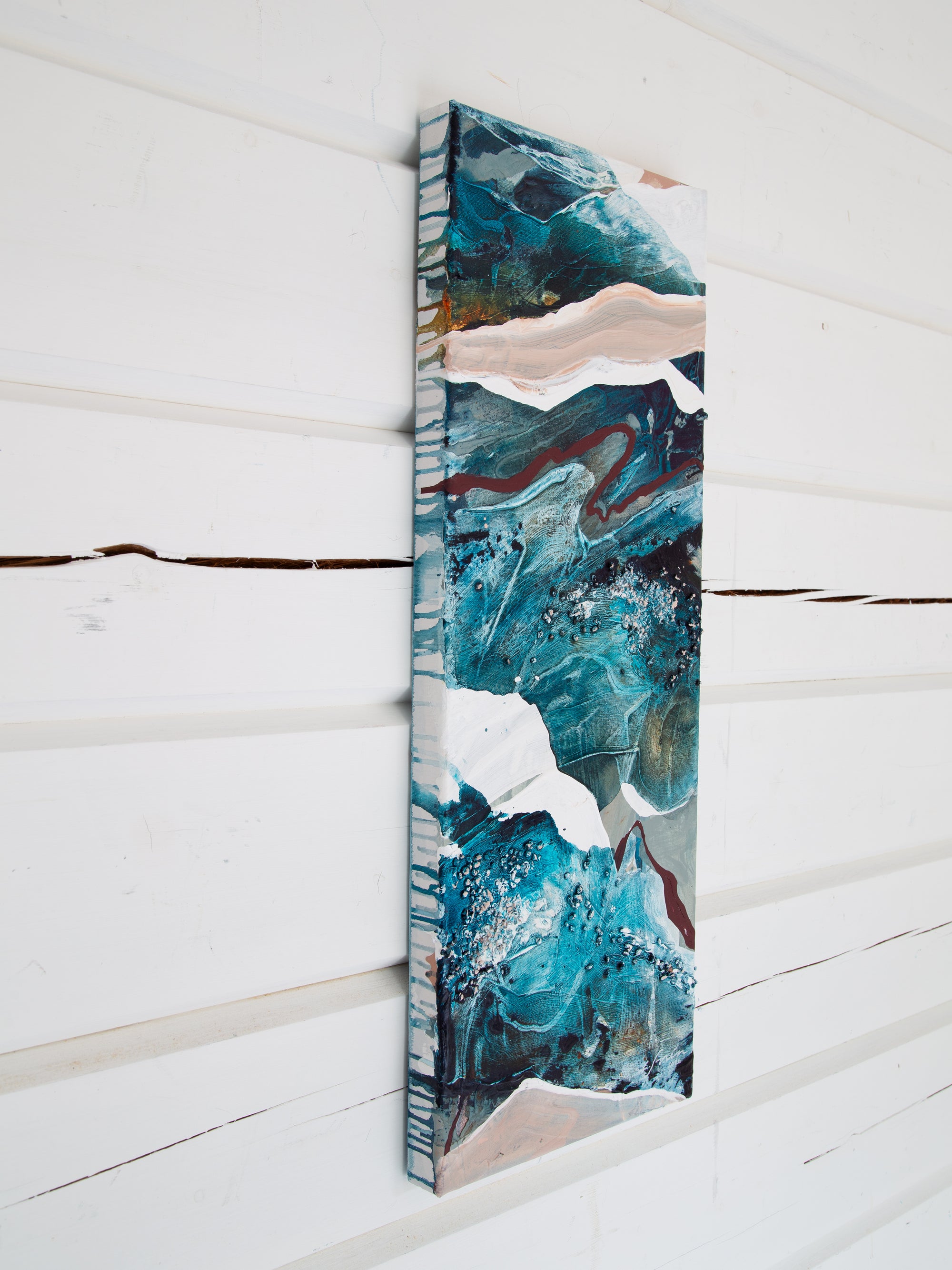 Abstract art piece on a vertical canvas against a white wooden background by Finnish abstract artist Lotta Sirén