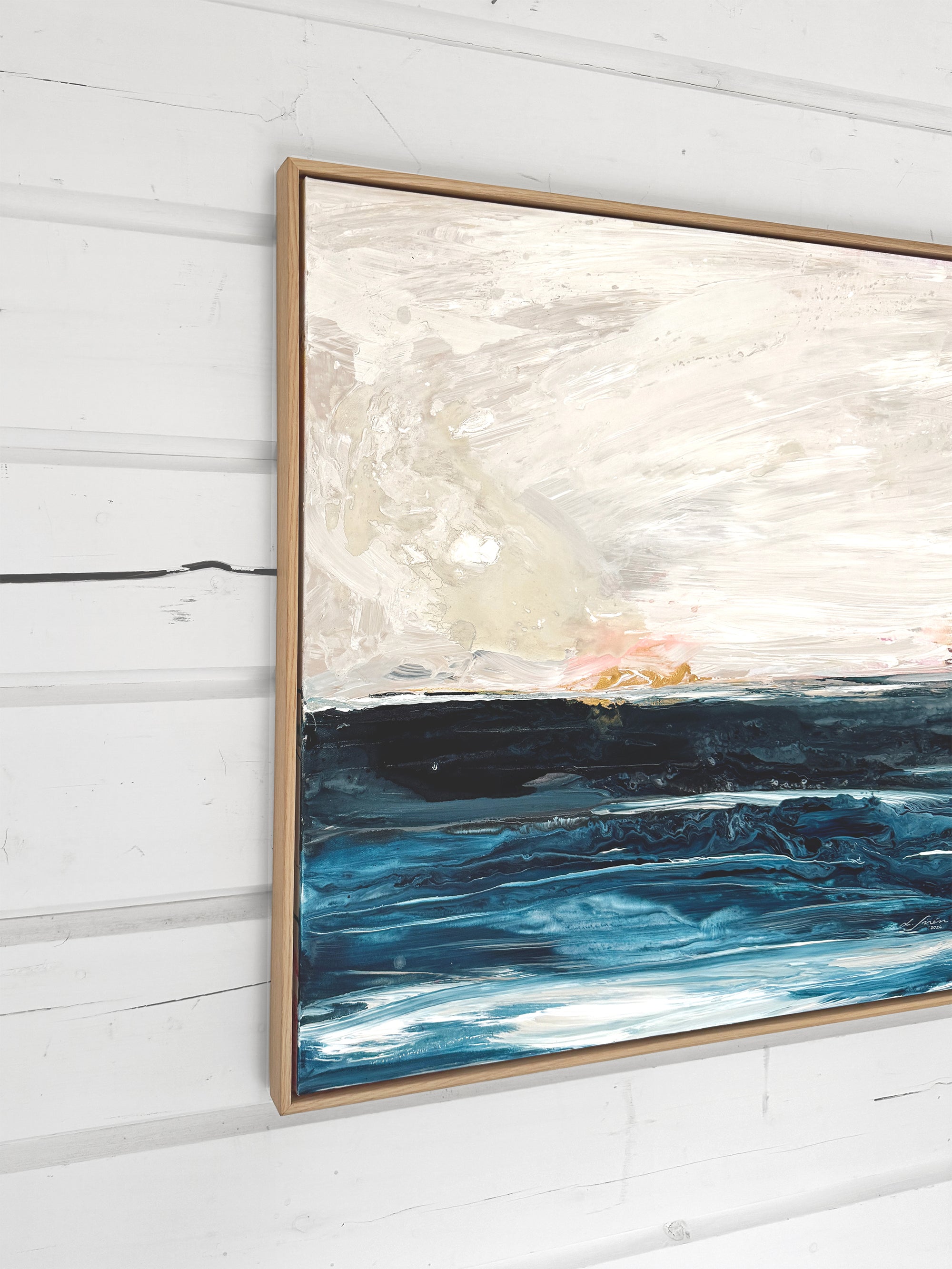 Abstract painting with blue and white tones on a light wooden wall by Finnish abstract artist Lotta Sirén