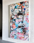Original abstract painting on a white wall.