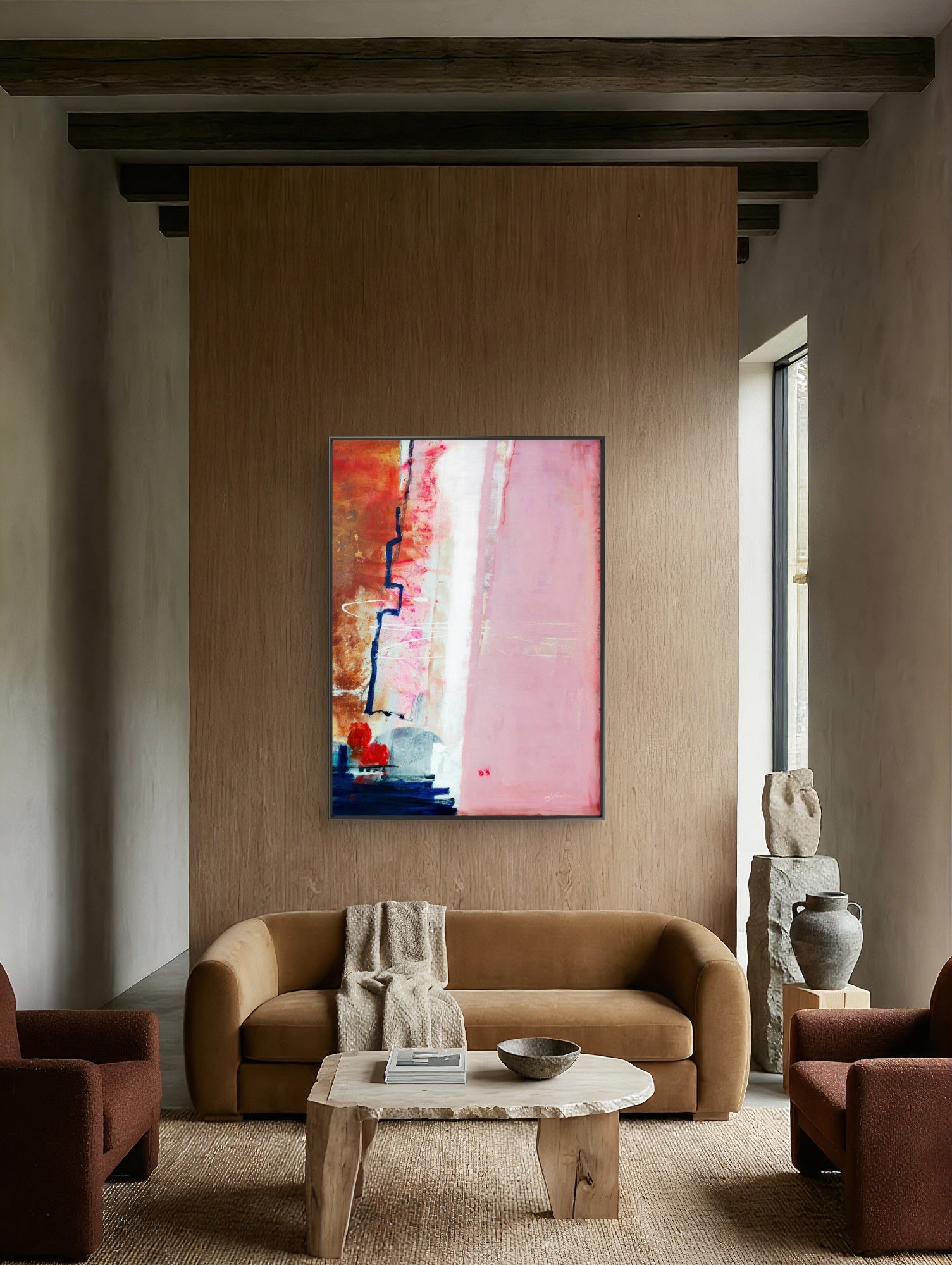 Speed Bump - Limited Edition Canvas Print with black frame. An abstract canvas print with pink, white and burnt sienna tones and a hint of red &amp; blue. Living room with a brown sofa, coffee table, and abstract painting on a wooden wall.