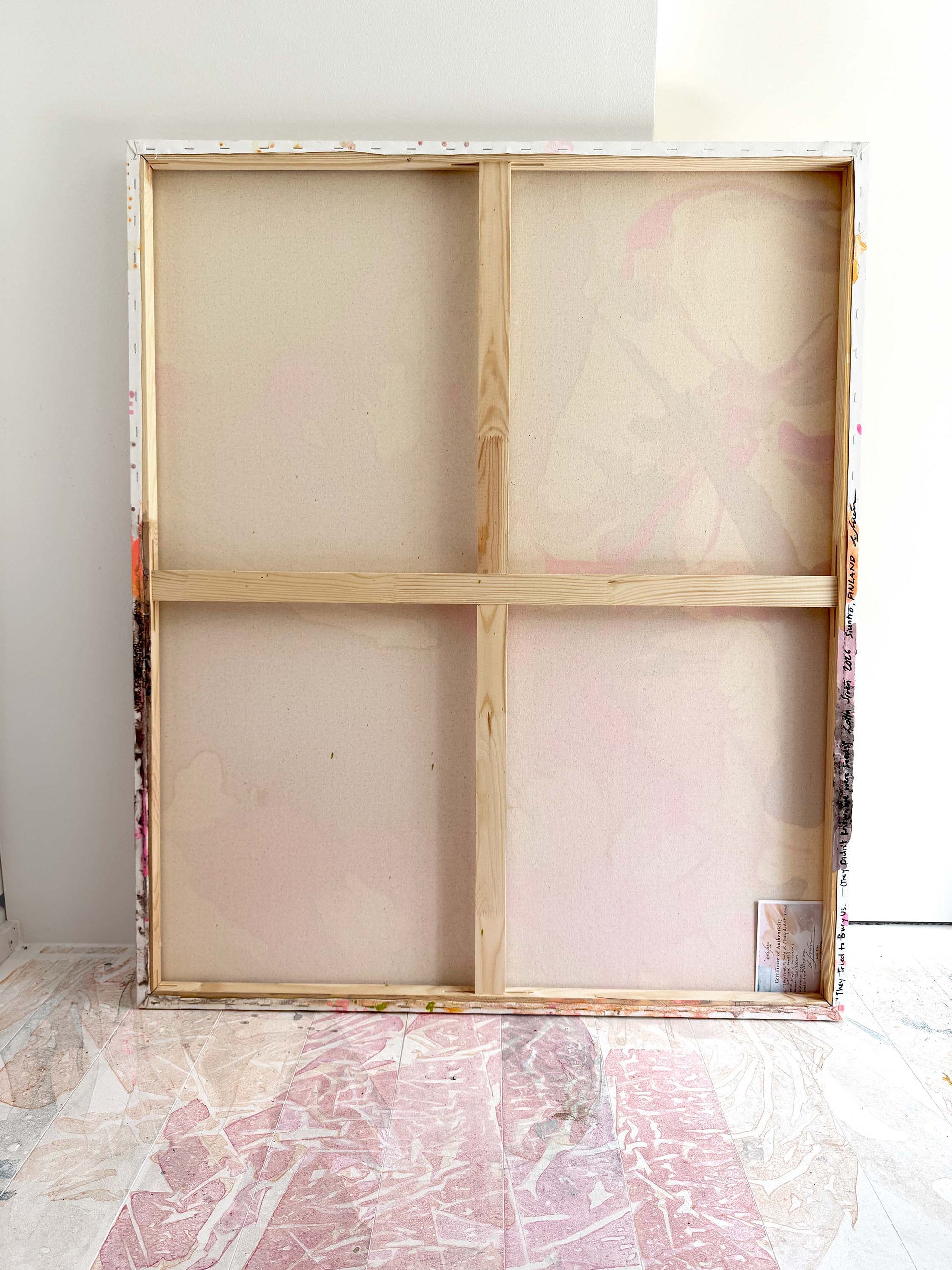 Wooden picture frame of a semi-abstract painting leaning against the wall