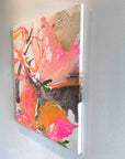 Abstract painting with pink, orange, and gold colors on a white wall by Finnish artist Lotta Sirén